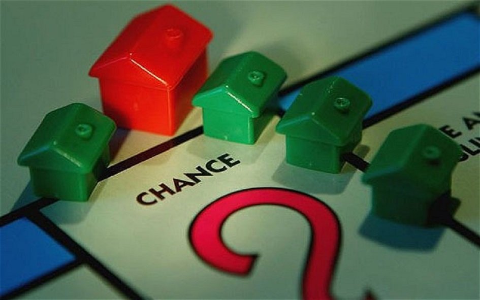 Buy-to-Let Mortgage Interest. Monopoly Houses in red and green on a Monopoly board on the Chance square. 