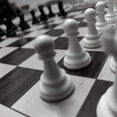Black and white photograph of chess pieces on a chess board