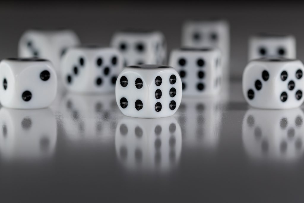 Multiple white dice on a grey background